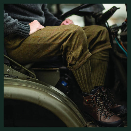 Tweed breeks, shooting stockings and brown walking boots worn while seated in a country vehicle.