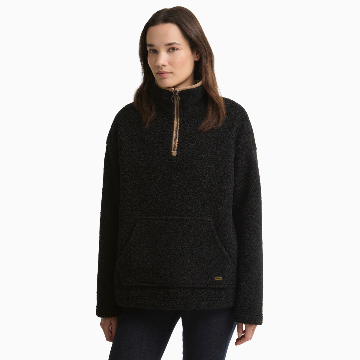 Woman wearing the Barbour Bamburgh Fleece in Black, showing the tan-trimmed zip neck and large front pocket.